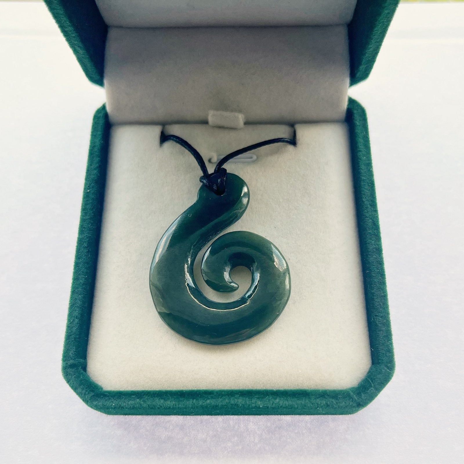 Carving Studio NZ hook-koru pounamu necklace in gift packaging
