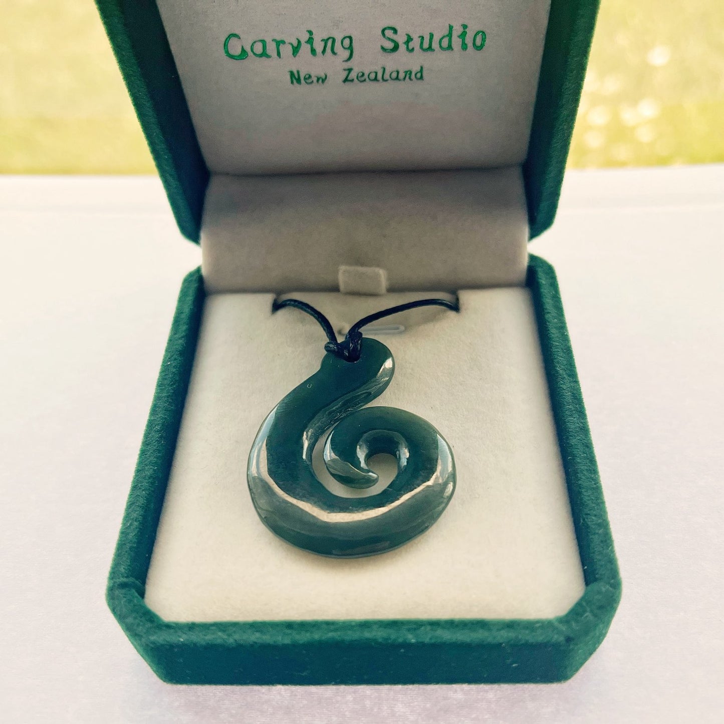 Greenstone Hook–Koru Pendant 42×32mm – Adjustable Cord, Velvet Gift Box Carving Studio NZ