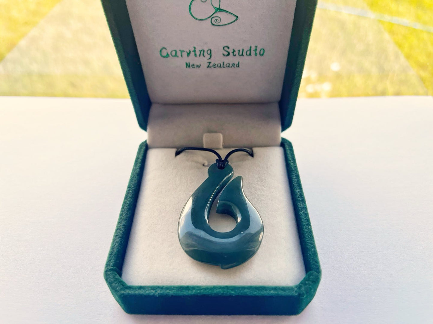 Branded gift box with greenstone hook pendant and adjustable cord