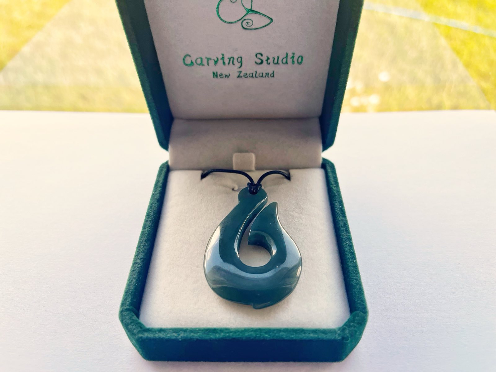 Branded gift box with greenstone hook pendant and adjustable cord