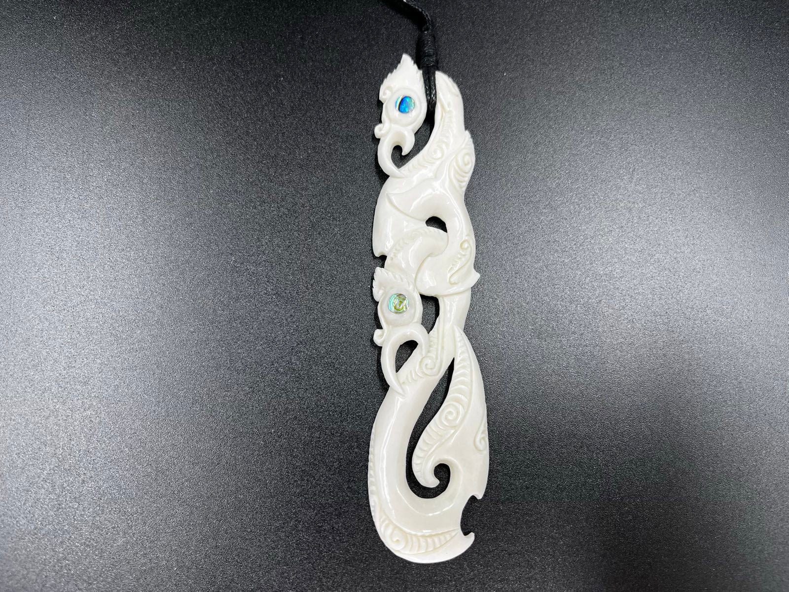 Māori Manaia bone carving pendant with paua shell eyes, 14cm long, NZ handmade